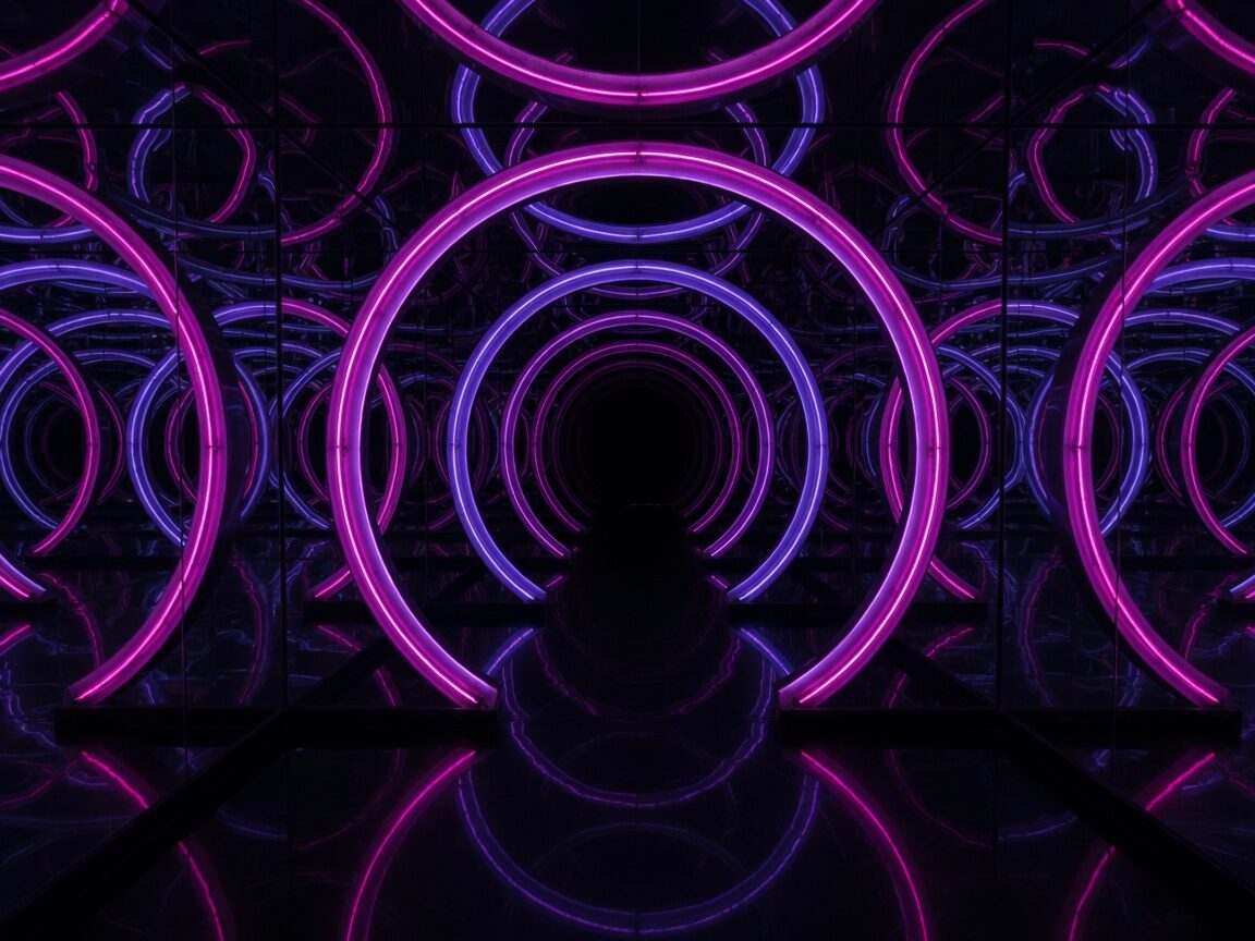 Infinity mirror installation of concentric magenta and violet neon rings receding into black.